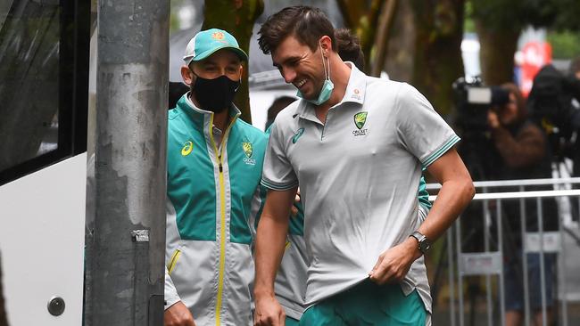 Australian bowlers Nathan Lyon, left, and Pat Cummin leave the team’s hotel in Melbourne on Monday. Picture: AFP