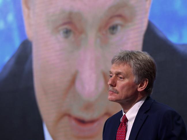 (FILES) In this file photo taken on December 17, 2020, Kremlin spokesman Dmitry Peskov sits in front of a screen displaying Russian President Vladimir Putin addressing his annual press conference via a video link from the Novo-Ogaryovo state residence, at the World Trade Centre's congress centre in Moscow. - Russia would only use nuclear weapons in the context of the Ukraine conflict if it were facing an 