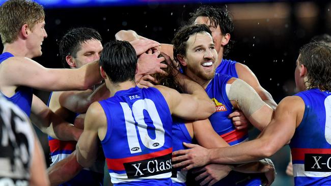 Western Bulldogs players flock to Roarke Smith after his first AFL goal. Picture: AAP Image/Sam Wundke.