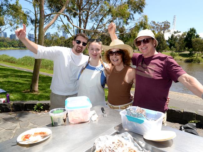 Tiernan O'Brien with Holly, Rachel and Ian Deakin beside the Yarra River. Picture: Andrew Henshaw