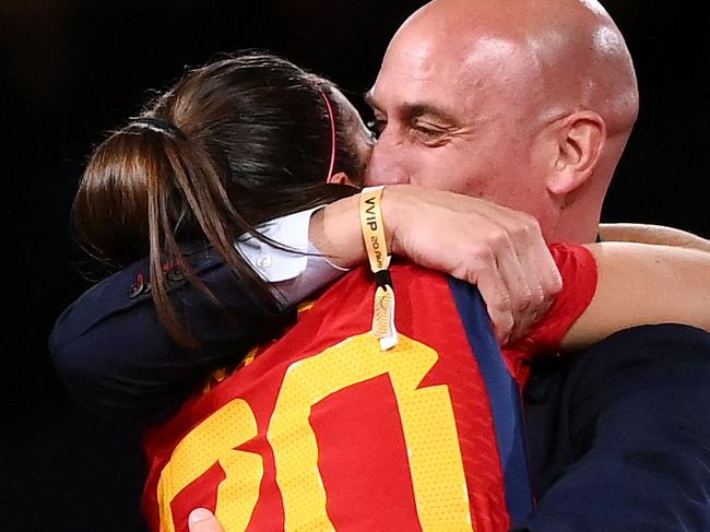 Spain's defender #20 Rocio Galvez is congratuled by President of the Royal Spanish Football Federation Luis Rubiales (R) next to Spain's Jennifer Hermoso after winning the Australia and New Zealand 2023 Women's World Cup final football match between Spain and England at Stadium Australia in Sydney on August 20, 2023. The Spanish football federation (RFEF) on August 26, 2023 threatened to take legal action over Women's World Cup player Jenni Hermoso's "lies" about her kiss with its president Luis Rubiales. (Photo by FRANCK FIFE / AFP)