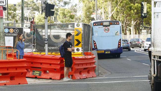 Pedestrians waiting to cross to Green square station at the Pedestrian crossing to Green Square station at the intersection of Botany Road and O’Riorden street, Zetland. Thedevelopment at 301 Botany Road has caused the closure of the pedestrian tunnel forcing all pedestrians to use the road closing at the busy intersection. Picture: John Appleyard