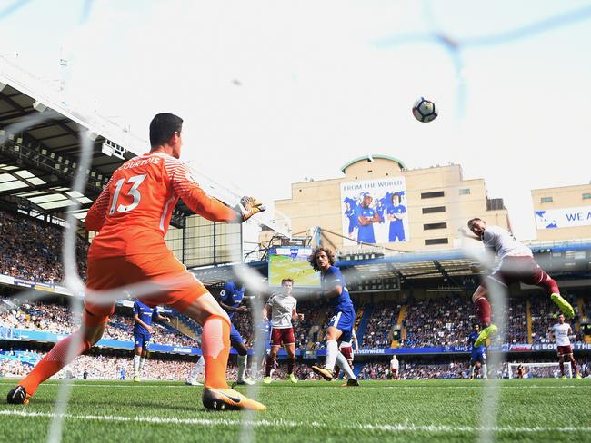 Sam Vokes scores one of Burnley’s three goals in their merited win over Chelsea.