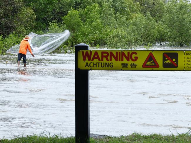 Despite council lifeguards closing three separate beaches in three weeks due to croc sightings, some locals are still taking risks around beaches, creeks and waterways where saltwater crocodiles may be present. A fisherman casts his net for prawns at the northern end of the Cairns Esplanade. Picture: Brendan Radke