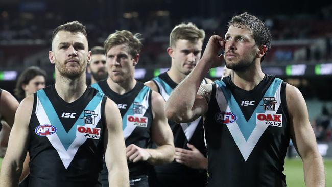 Captain Travis Boak scratches his head as he leads Port Adelaide off Adelaide Oval after Friday night’s loss to Essendon. PICTURE SARAH REED