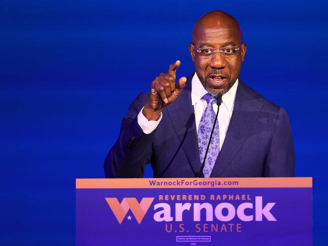 ATLANTA, GEORGIA - NOVEMBER 08: Sen. Raphael Warnock (D-GA) gives a speech at his Election night party at Atlanta Marriott Marquis on November 08, 2022 in Atlanta, Georgia. Sen. Warnock is in a very tight race with Republican challenger Herschel Walker. If neither candidate receives 50 percent plus one vote needed, they will head to a runoff in December.   Michael M. Santiago/Getty Images/AFP