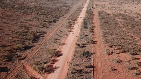 Looking down the Plenty Highway toward the scene of crash where Kumanjayi Bloomfield died, (approximate to white police vehicle parked horizontally and where the other officer stood guard at the scene).