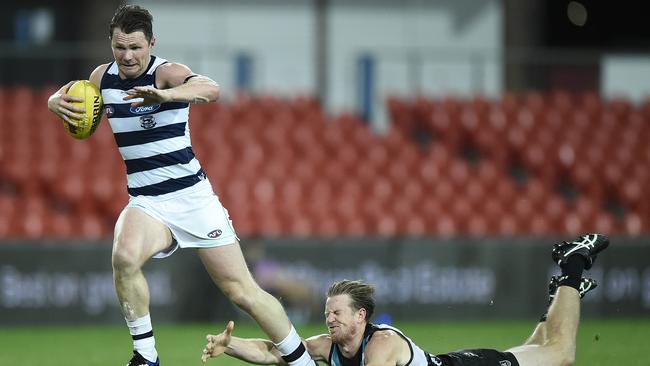 Geelong’s Patrick Dangerfield breaks free of a tackle during the Cats’ win over Port Adelaide at Metricon Stadium on Fiday night. Picture: Getty Images