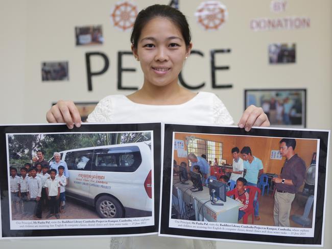 Deputy Principal Helen Lam with photographs of Teach4Peace’s trip to Cambodia. Picture: Tim Clapin