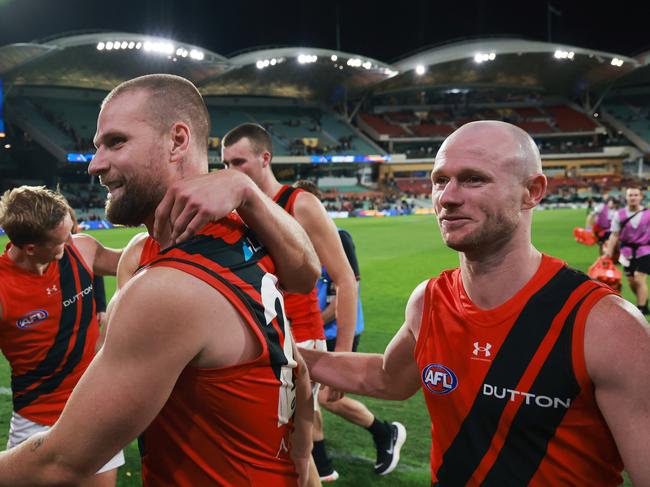 ADELAIDE, AUSTRALIA - APRIL 19: Jake Stringer and Nick Hind of the Bombers celebrate their win during the 2024 AFL Round 06 match between the Adelaide Crows and the Essendon Bombers at Adelaide Oval on April 19, 2024 in Adelaide, Australia. (Photo by James Elsby/AFL Photos via Getty Images)