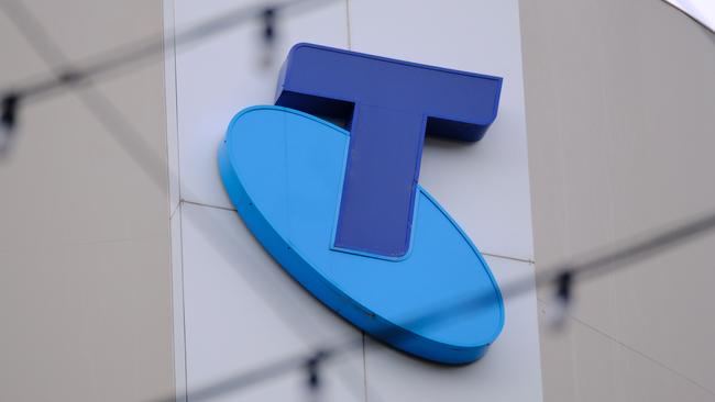 MELBOURNE, AUSTRALIA - NewsWire Photos OCTOBER 4, 2022. Generic photo people walking past the Telstra logo in Melbourne..Picture: NCA NewsWire / Luis Enrique Ascui