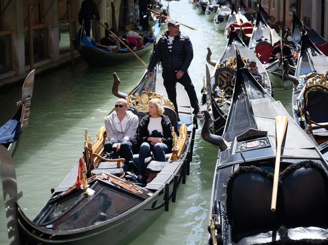 A gondolier takes tourists through the canals of Venice, near San Marco Square. Now day-trippers need a five-euro ticket just to enter the city. Picture: Marco Bertorello / AFP