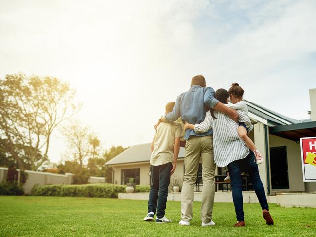 generic; couple in front of house for sale; house sold; real estate; hugging; iSTOCK