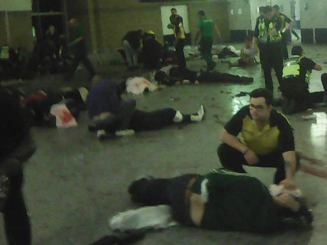 Helpers attend to people inside the Manchester Arena after a bomb exploded in the foyer. Picture: PA Wire