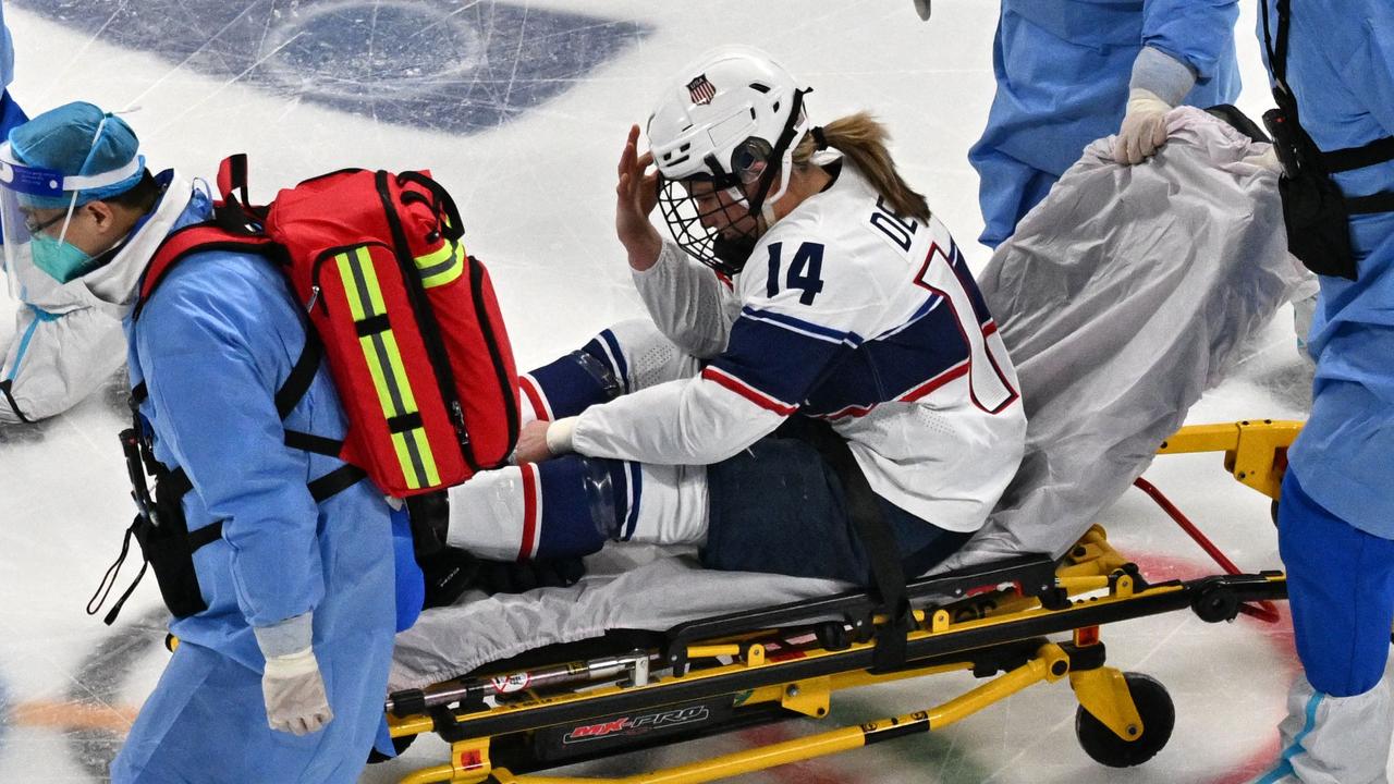 USA's Brianna Decker is taken out of the rink on a trolley. Photo by ANTHONY WALLACE / AFP.