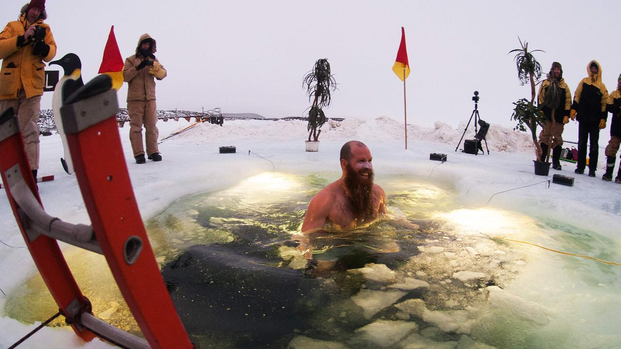 Plumber Dan Gough plunges into the icy pool as part of midwinter celebrations at Australia’s Davis research station. Picture: AFP