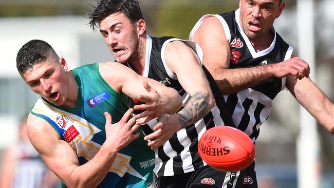 East Sunbury's Tom Cree locks horns with Moonee Valley's Dillon Rogan and Cory McGrath. Picture: Josie Hayden