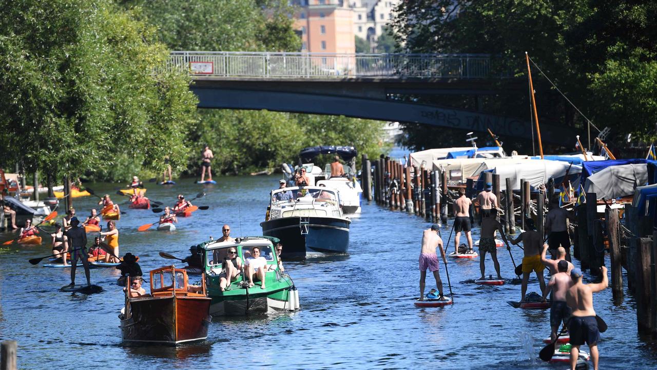 Swedes enjoy the summer weather on a canal in Stockholm this month. Picture: Fredrik SANDBERG / TT News Agency / AFP.