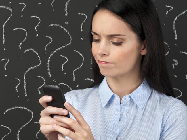Mobile phone service concept - Woman texting with question marks on a blackboard.  confused investor generic.