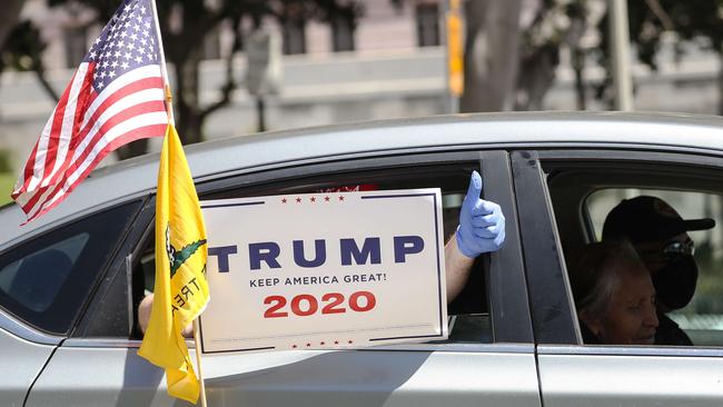 A Trump supporter joins a vehicle caravan protest outside City Hall in Los Angeles. Picture: AFP