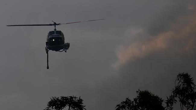 A water bombing helicopter helps to contain the Gospers Mountain fire as it burned towards Bilpin on December 10, as temperatures climbed to the low 40s. (AAP Image/Dean Lewins)