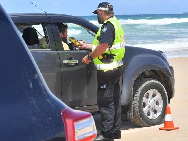 Police officers checking on the beach traffic at Teewah earlier this year.