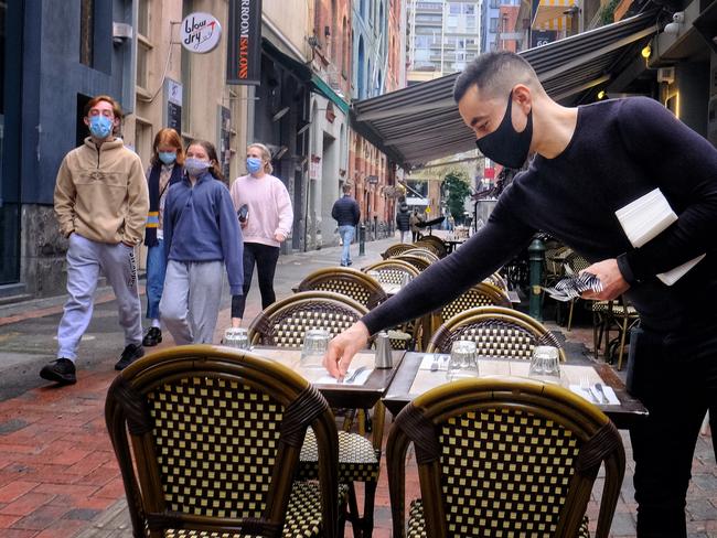 Staff preparing for trading while wearing masks. Picture: Luis Ascui