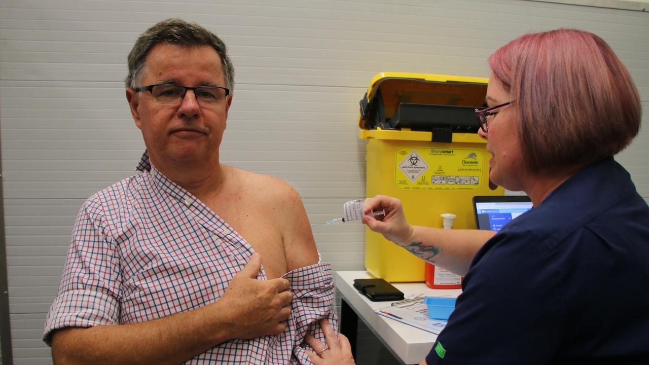 Bundaberg Hospital Intensive Care Unit Clinical Director Dr Doug Wilkinson receiving his COVID-19 vaccine from Sherine Binder.