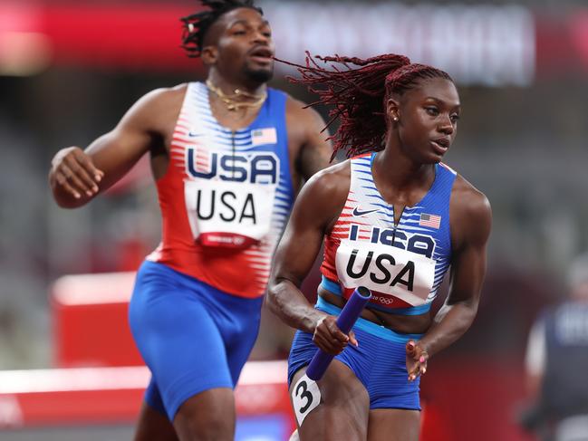 Lynna Irby takes off after receiving the baton from Elija Godwin. (Photo by Michael Steele/Getty Images)