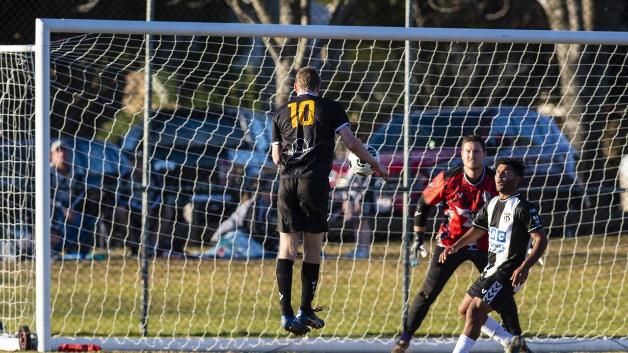 Noah Cochran (left) of West Wanderers defended by Willowburn goalkeeper Matthew Eilers and Adnan Alharoni in FQPL Men Darling Downs Presidents Cup football at West Wanderers, Sunday, July 24, 2022. Picture: Kevin Farmer