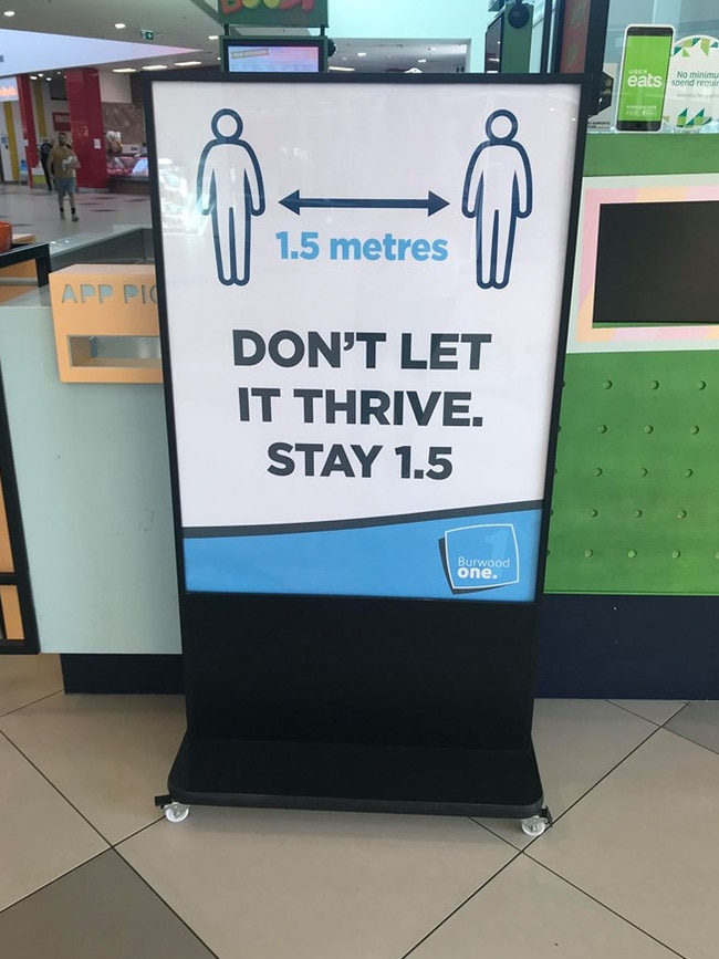 A sign urging visitors to keep their distance at Burwood One shopping centre.