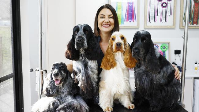 Award-winning dog groomer Tara Tinsey of Cute as a Button dog grooming with her four Cocker Spaniels Olive, Bentley Maple and Winston at the home salon in the Goldsborough Valley. Picture: Brendan Radke