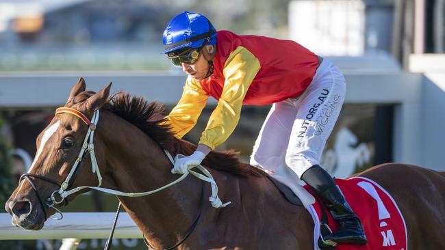 Jockey Ryan Wiggins rides Inquiry to victory in race 7, the Mittys Spear Chief Handicap, during Doomben Race Day at Doomben Racecourse in Brisbane, Saturday, June 27, 2020. (AAP Image/Supplied by Michael McInally, Racing Queensland)