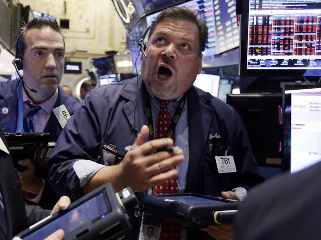 FILE - In this Aug. 24, 2015 file photo, trader John Santiago, center, works on the floor of the New York Stock Exchange, in New York. As stocks swung wildly last month, average investors pulled a net $9.8 billion out of mutual funds targeting U.S. stocks and put $9 billion in the money market during the week ending Aug. 26, according to the Investment Company Institute, a trade group. The next week, the market rebounded and they reversed course, sticking $1.8 billion into U.S. funds. (AP Photo/Richard Drew, File)