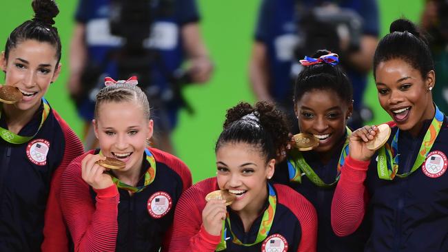 Unstoppable! US gymnasts Alexandra Raisman, Madison Kocian, Lauren Hernandez, Simone Biles and Gabrielle Douglas celebrate with their gold medals. Picture: Emmanuel Dunand