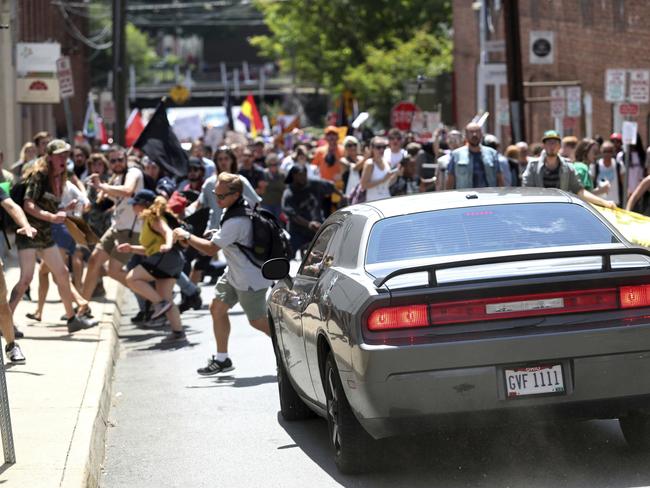 A vehicle drives into a group of protesters demonstrating against a white nationalist rally in Charlottesville. Picture: AP