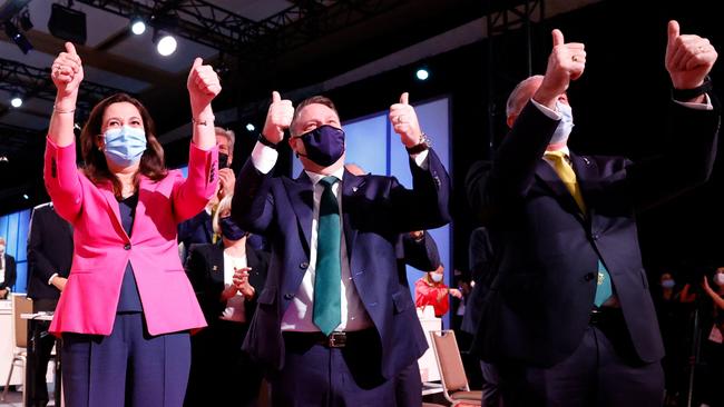 Queensland Premier Annastacia Palaszczuk, left, Brisbane mayor Adrian Schrinner and federal Sports Minister Richard Colbeck celebrate in Tokyo on Wednesday. Picture: AFP