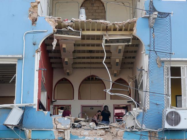 A Lebanese couple inspect the damage to their house in an area overlooking the destroyed Beirut port. Picture: Joseph Eid/AFP