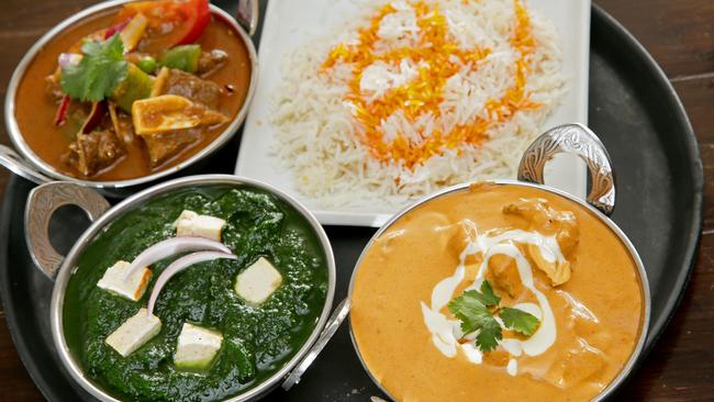 A trio of favourites: Gur Taj’s butter chicken, saag and Lamb Do Piaza, with rice. Picture: Troy Snook