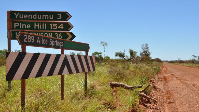 A road sign points to nearby Yuendumu.