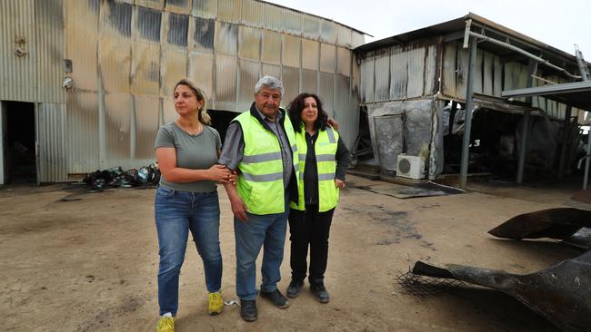 Joe Giangregorio with his daughters Juliet and Maria at their Rainbow Fresh packing shed, which was destroyed in a $2.5m fire. Picture: Tait Schmaal.