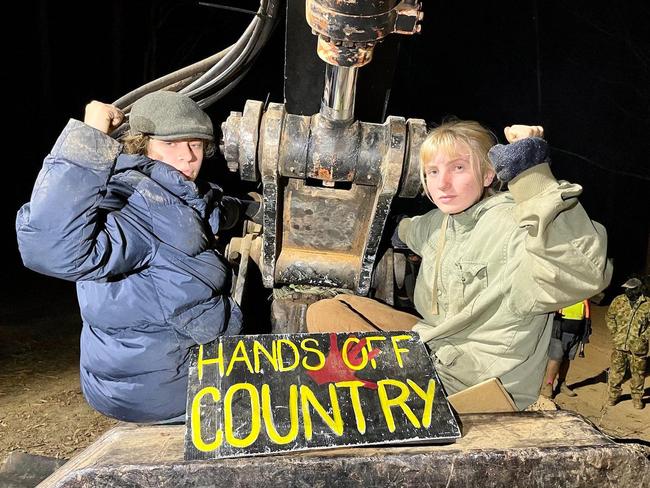 Two young women lock on to heavy machinery at the anti-logging protest at Newry State Forest on the southern outskirts of Coffs Harbour on August 1, 2023. Picture: Facebook