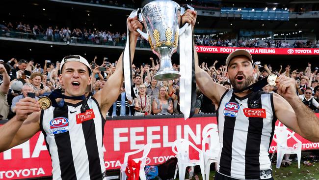 Nick Daicos and Steele Sidebottom of the Magpies celebrate with the premiership cup during the 2023 AFL Grand Final. Picture: Dylan Burns