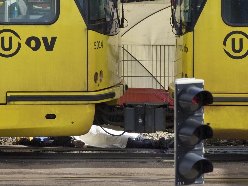 A body is covered with a blanket next to a tram following a shooting in Utrecht, Netherlands. Picture: AP