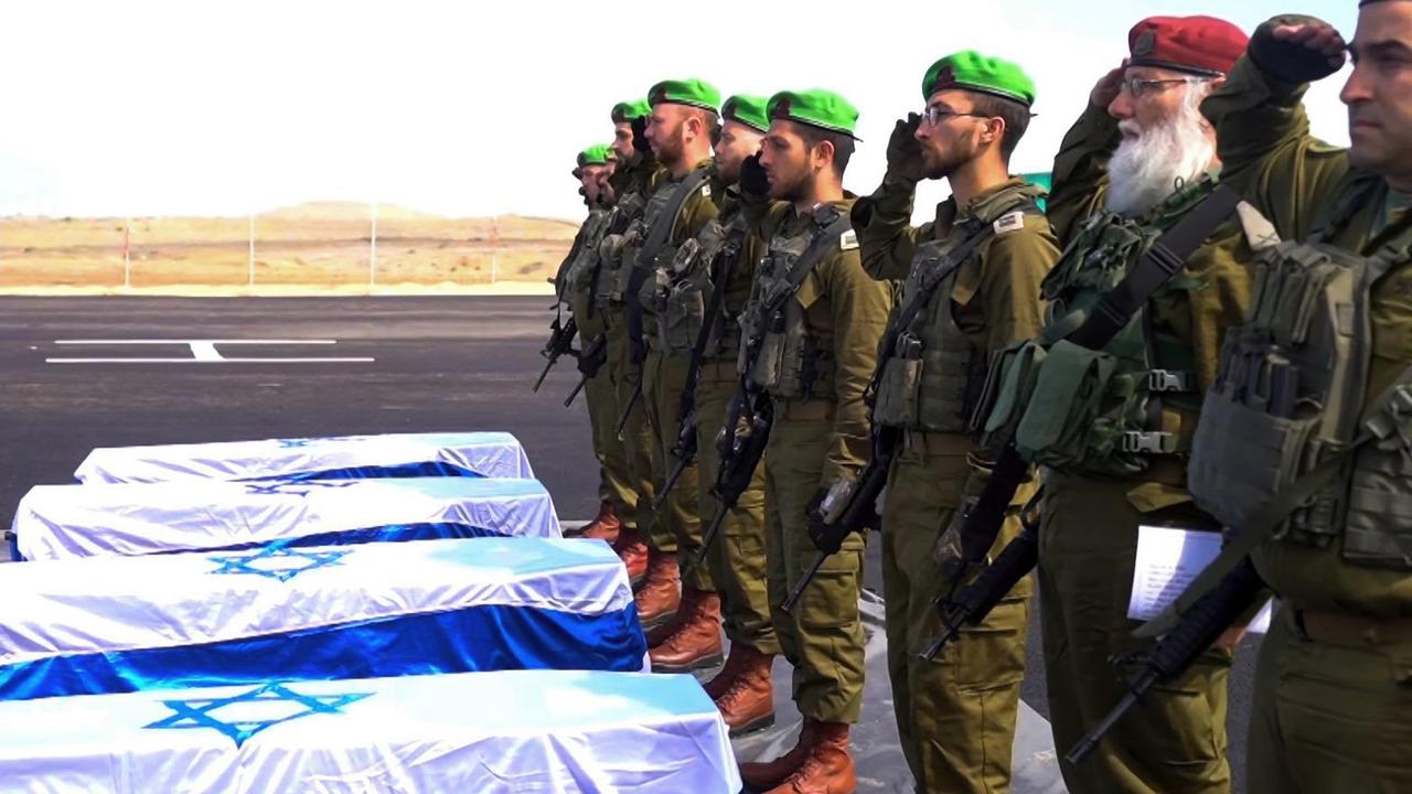 Israeli soldiers carry the coffins of what were believed to be deceased hostages Oded Lifschitz, Shiri Bibas and her two children Kfir and Ariel Bibas, who were kidnapped during the deadly October 7, 2023 attack. Picture: Government Press Office / GPO