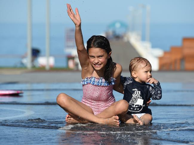 Ruby and her little brother Axel try out the water feature at the newly developed Henley Square. Picture: Naomi Jellicoe