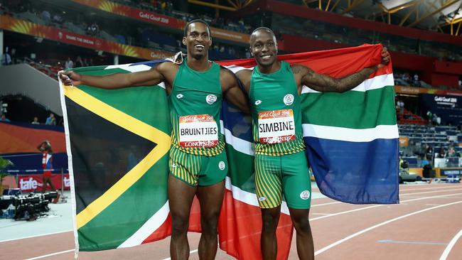 Akani Simbine celebrates winning gold with silver medalist Henricho Bruintjies.