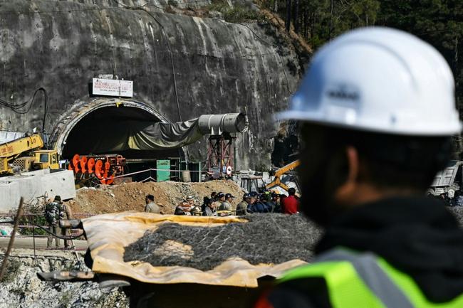 A rescue officer stands near the entrance to the Silkyara tunnel: engineers began digging on November 12 through some 57 metres (187 feet) of earth, concrete and rubble