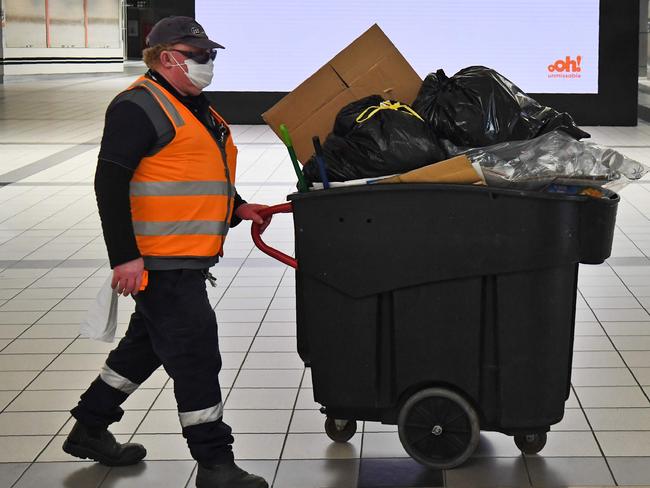 A worker pushes a bin at Melbourne's Flinders Street station. Picture: William West