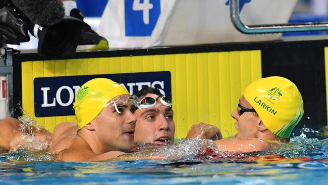 Mitch Larkin celebrates with his teammates Benjamin Treffers and Zac Incerti after a trifecta in the pool.